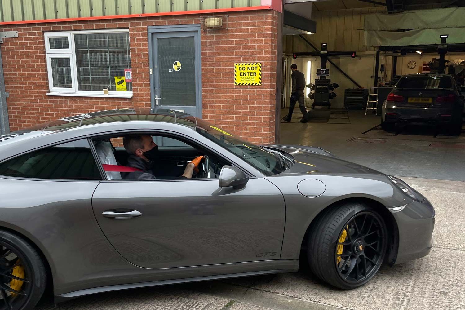 car driving into workshop