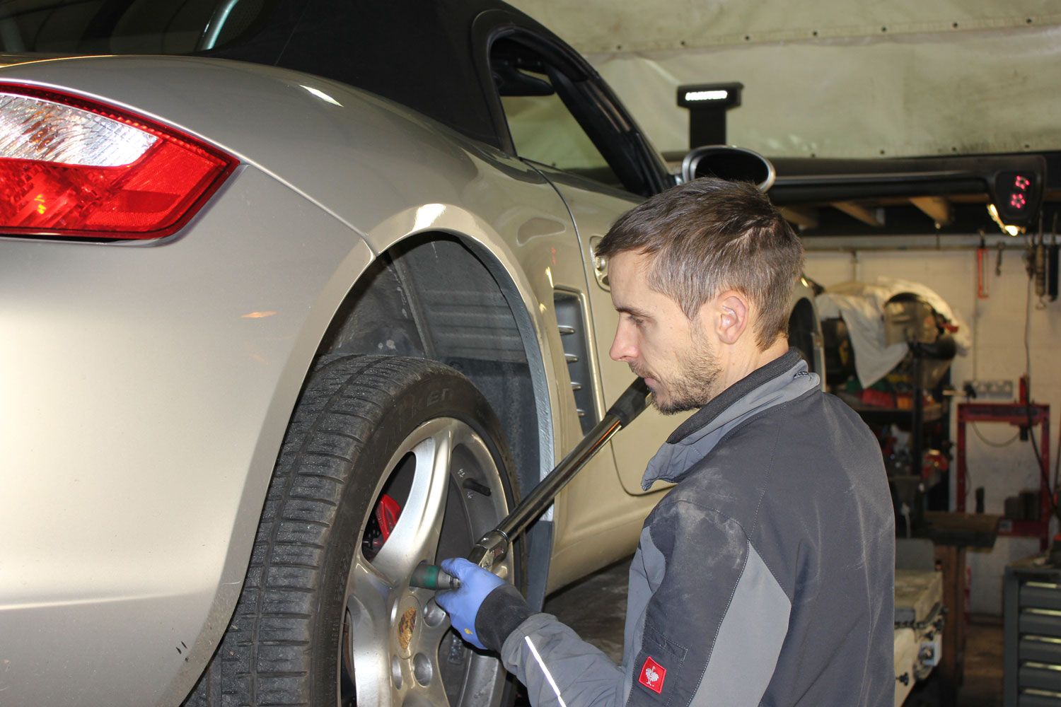 man at work on car whee